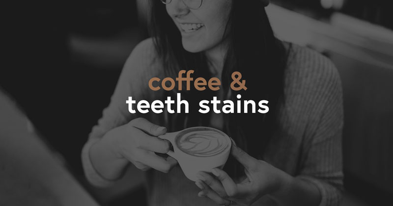 Smiling woman holding a cup of coffee with the phrase 'coffee & teeth stains' overlayed, suggesting a focus on the impact of coffee on dental hygiene.